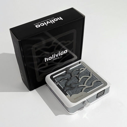 Pochłaniacz pyłu Holivica Pro 2 stojący obok czarnego pudełka z logo Holivica Pro 2 – opakowanie produktowe.